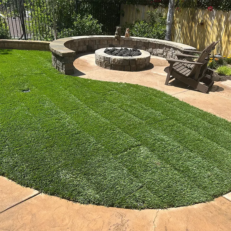 Outdoor fire pit patio with seating wall and artificial turf installed by Ultra Landscaping in East County San Diego